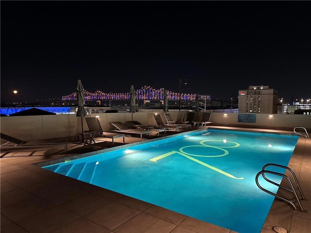 Rooftop pool with the illuminated bridge in the evening